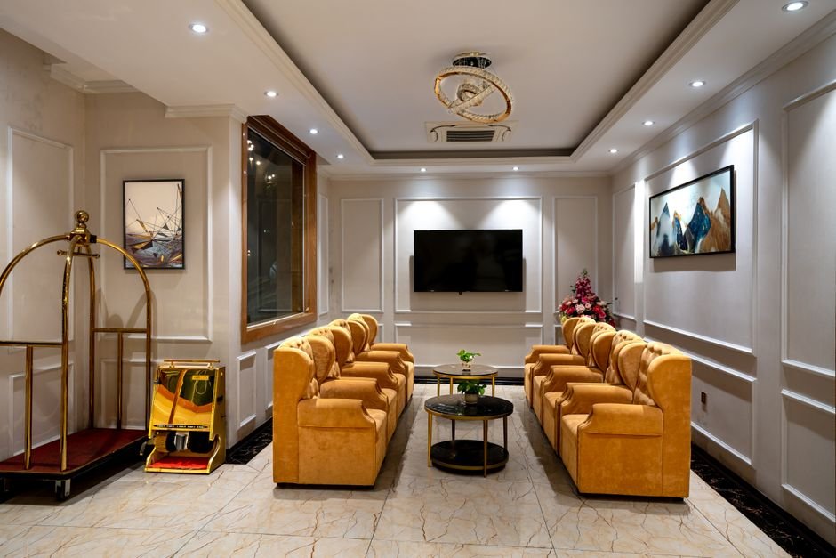 Luxurious hotel lobby featuring stylish armchairs, lighting, and decor.